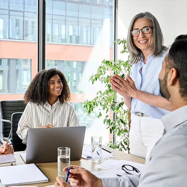 A group of workers in a sunny corporate office having an easygoing discussion