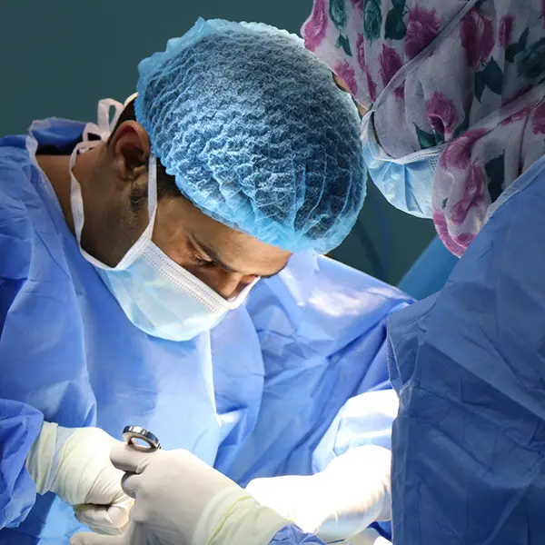 A closeup of two surgeons working in a sterile work environment
